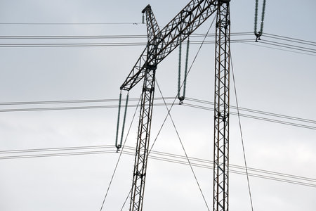 High voltage power line with insulation divider of electric power wires for safe delivering of electrical energy through steel cable on long distanceの写真素材