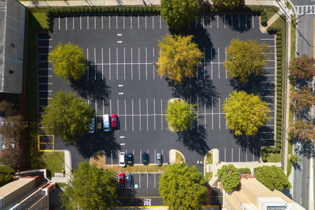 Aerial view of many colorful cars parked on parking lot on apartment building backyard. Place for vehicles in front of residential condoの写真素材
