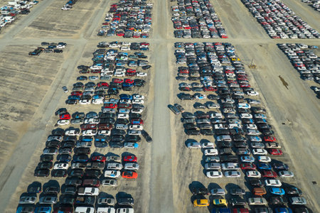 Used damaged cars on auction reseller company big parking lot ready for resale services. Sales of secondhand vehicles for rebuilt or salvage titleの写真素材