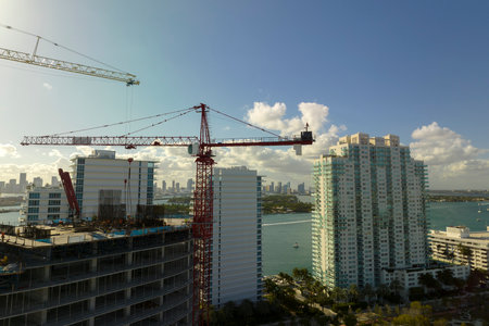 Aerial view of new developing residense in american urban area. Tower cranes at industrial...