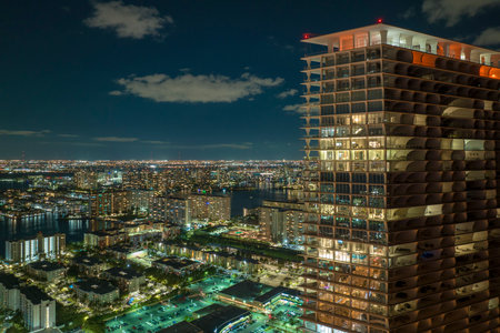 Aerial view of residential high-rise skyscraper at night in Sunny Isles Beach city in Florida, USA. Housing development in modern american urban areaの写真素材