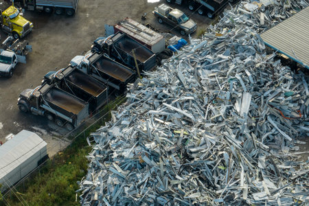 Beg pile of scrap aluminum metal siding from ruined houses after hurricane Ian swept through Florida. Recycle of broken parts of mobile homesの写真素材
