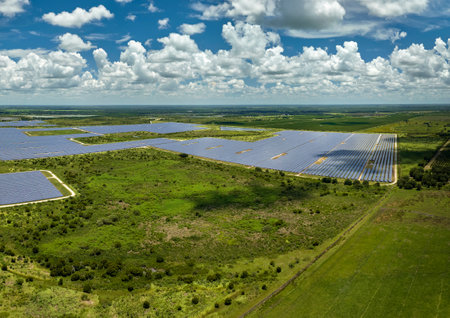 Aerial view of sustainable electrical power plant between agricultural farmlands with photovoltaic panels for producing clean electric energy. Concept of renewable electricity with zero emissionの写真素材