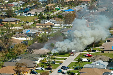 Burning residential house on fire with smoke and flames after short circuit spark ignited wooden...