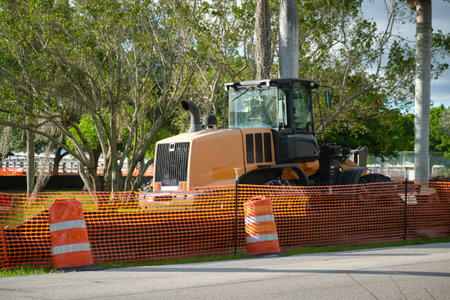 Protective restriction barrier at industrial construction site. Safety mesh fence for pedestrians
