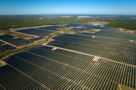Aerial view of big sustainable electric power plant with many rows of solar photovoltaic panels for producing clean electrical energy. Renewable electricity with zero emission conceptの写真素材
