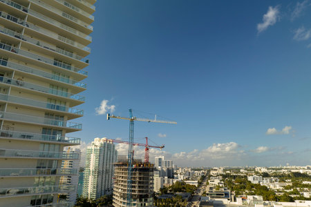 New construction site of developing residense in american urban area. Industrial tower lifting...