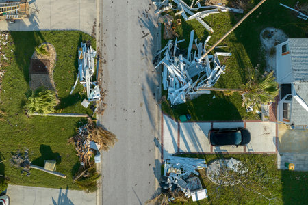 Piles of rubbish on street side from severely damaged houses after hurricane Ian in Florida mobile home residential area. Consequences of natural disasterの写真素材