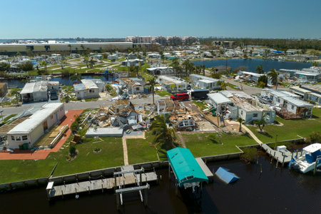Severely damaged houses after hurricane Ian in Florida mobile home residential area. Consequences of...