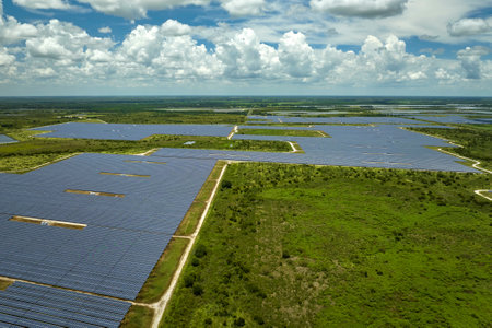 Aerial view of sustainable electrical power plant between agricultural farmlands with photovoltaic...
