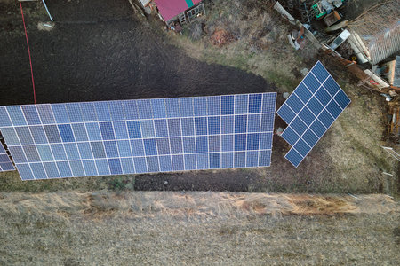 Solar photovoltaic panels mounted on stand-alone frame on backyard ground for generating of clean...