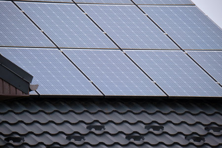 Residential house with rooftop covered with solar photovoltaic panels for producing of clean...