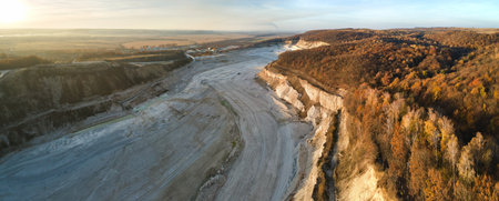 Aerial view of open pit mining site of limestone materials for construction industry with excavators...