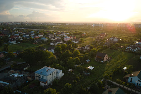 Aerial view of residential houses in suburban rural area at sunsetの写真素材