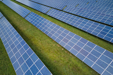 Aerial view of big sustainable electric power plant with many rows of solar photovoltaic panels for producing clean electrical energy. Renewable electricity with zero emission conceptの写真素材