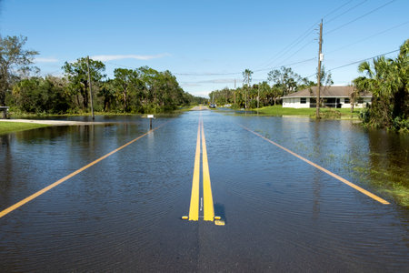 Flooded american street in Florida residential area. Hazardous driving conditions. Consequences of hurricane natural disasterの写真素材