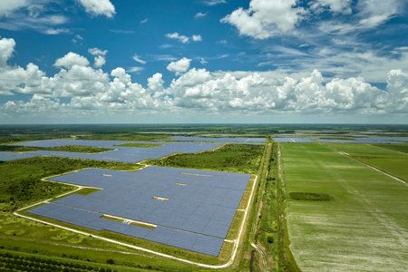 Aerial view of big sustainable electric power plant with many rows of solar photovoltaic panels for producing clean electrical energy. Renewable electricity with zero emission conceptの写真素材