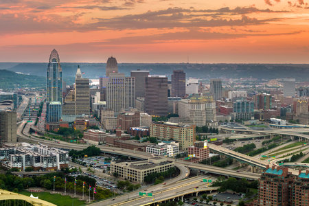 Aerial view of downtown district of Cincinnati city in Ohio, USA at sunset. Brightly illuminated high skyscraper buildings in modern American midtownの写真素材