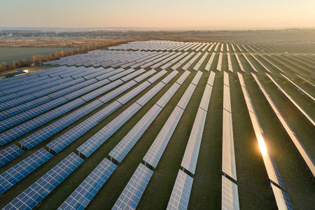 Aerial view of large sustainable electrical power plant with rows of solar photovoltaic panels for producing clean electric energy in evening. Concept of renewable electricity with zero emissionの写真素材