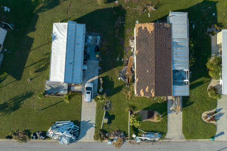 Consequences of natural disaster. Severely damaged houses after hurricane Ian in Florida mobile home...