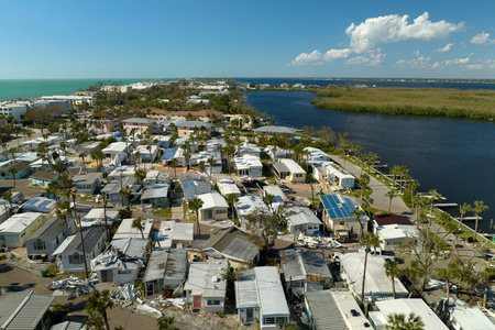 Aerial view of heavily damaged by hurricane Ian houses in Florida mobile home residential area....