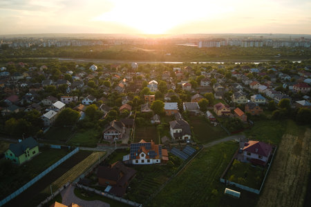 Aerial view of residential houses in suburban rural area at sunsetの写真素材