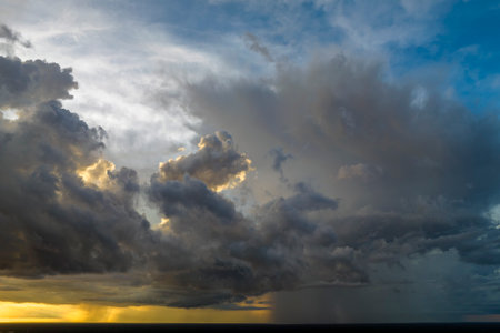 Cumulonimbus clouds forming before thunderstorm on evening sky. Changing stormy cloudscape weather...