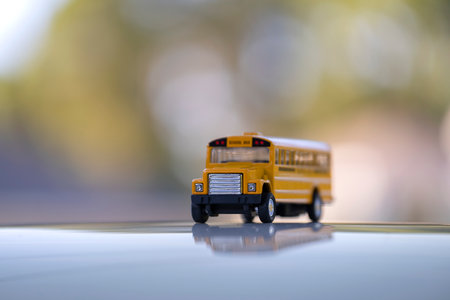 Little model of american yellow school bus outdoor. Concept of education safety in the USA