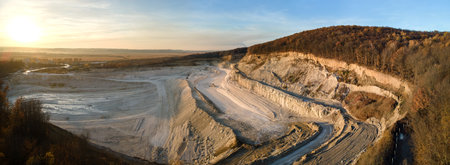 Aerial view of open pit mining site of limestone materials for construction industry with excavators and dump trucksの写真素材