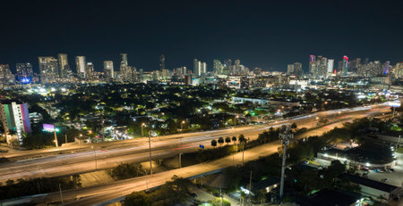 Aerial view of american highway junction at night with fast driving vehicles in Miami, Florida. View from above of USA transportation infrastructureの写真素材