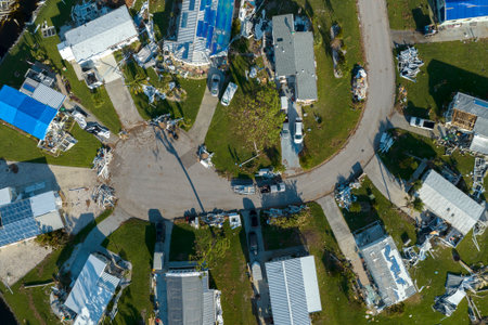 Property damage from strong hurricane winds. Mobile homes in Florida residential area with destroyed...