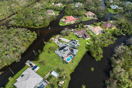 Heavy flood with high water surrounding residential houses after hurricane Ian rainfall in Florida residential area. Consequences of natural disasterの写真素材