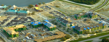 Aerial view of unfinished frames of apartment buildings ready for mounting wooden roof beams under...