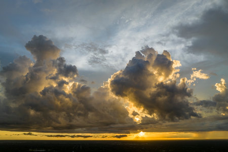 Colofrul clouds brightly illuninated by setting sun on evening sky. Changing cloudscape weather at...