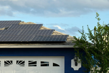 Residential house with rooftop covered with solar photovoltaic panels for producing of clean...