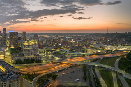 USA transportation infrastructure concept. View from above of American big freeway intersection in Cincinnati city, Ohio at night with fast moving cars and trucksの写真素材