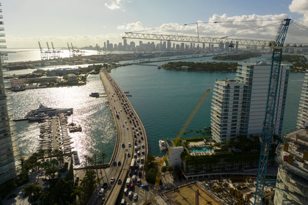 Tower lifting cranes at high residential apartment building construction site. Real estate development in Miami urban areaの写真素材