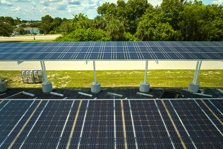 Aerial view of solar panels installed as shade roof over parking lot for parked cars for effective...