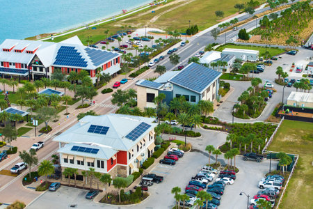 Florida office buildings with solar roof in small autonomous town. Blue photovoltaic panels for producing clean ecological electric energy. Investing in renewable electricity conceptの写真素材