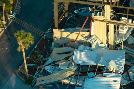 Warehouse with motorboats and yachts destroyed by hurricane winds in Florida coastal area. Natural...