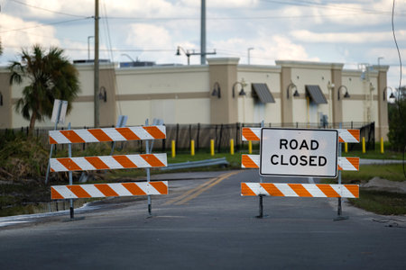Yellow protective barrier at street construction site. Warning road sign about utility workの写真素材