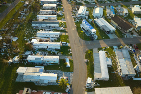 Severely damaged houses after hurricane Ian in Florida mobile home residential area. Consequences of...