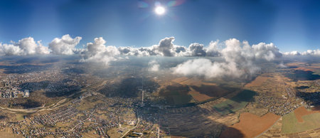 Aerial view at high altitude of earth covered with puffy cumulus clouds forming before rainstorm