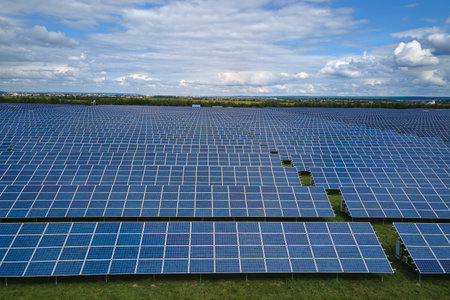 Aerial view of big sustainable electric power plant with many rows of solar photovoltaic panels for...