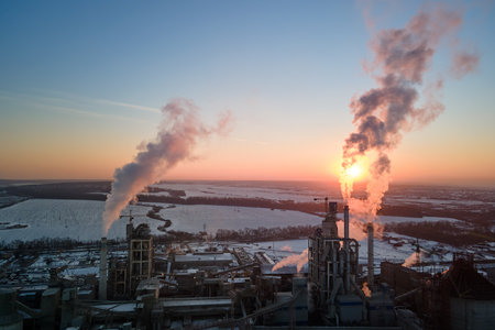Aerial view of cement factory tower with high concrete plant structure at industrial production area at sunset. Manufacturing and global industry conceptの写真素材