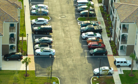 Cars parked on parking place of new apartment condos in Florida suburban area. Family housing in quiet neighborhood. Real estate development in american suburbsの写真素材