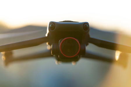 Drone quadcopter with digital camera and fast rotating propellers flying taking video and pictures