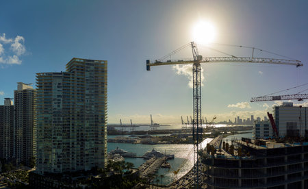 New construction site of developing residense in american urban area. Industrial tower lifting...