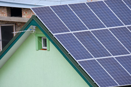 Residential house with rooftop covered with solar photovoltaic panels for producing of clean...