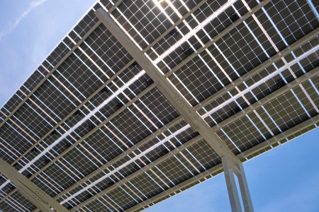 Solar panels installed as shade roof over parking lot for parked electric cars for effective...